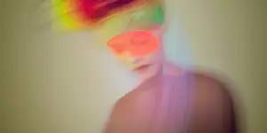 Blurred image of a person with their eyes masked to depict BDSM as an accessible world of pleasure for disabled people